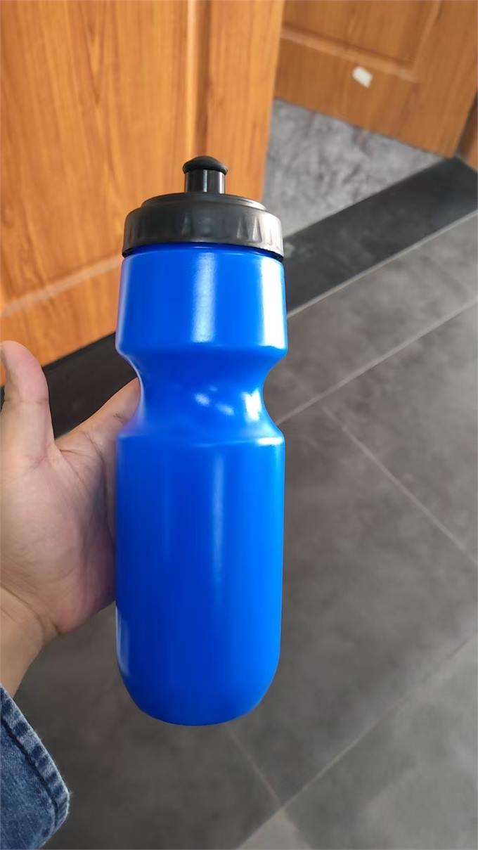 Blue sports squeeze bottle with black lid