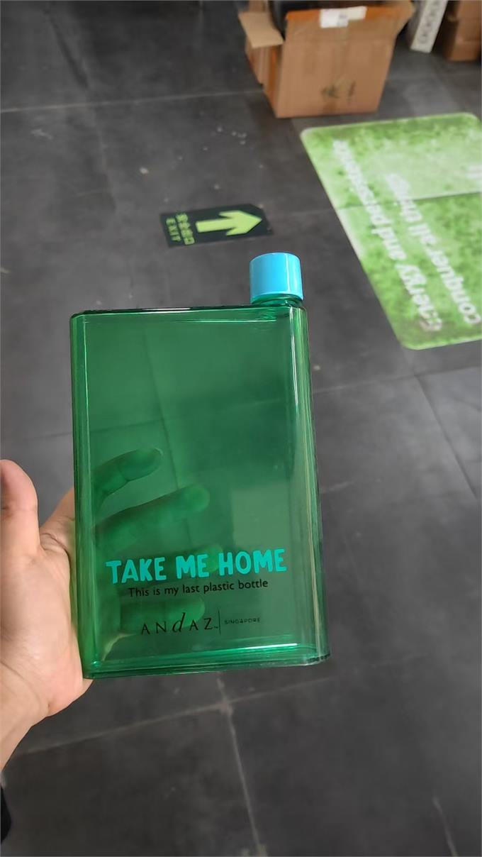 Flat green reusable water bottle with printed message