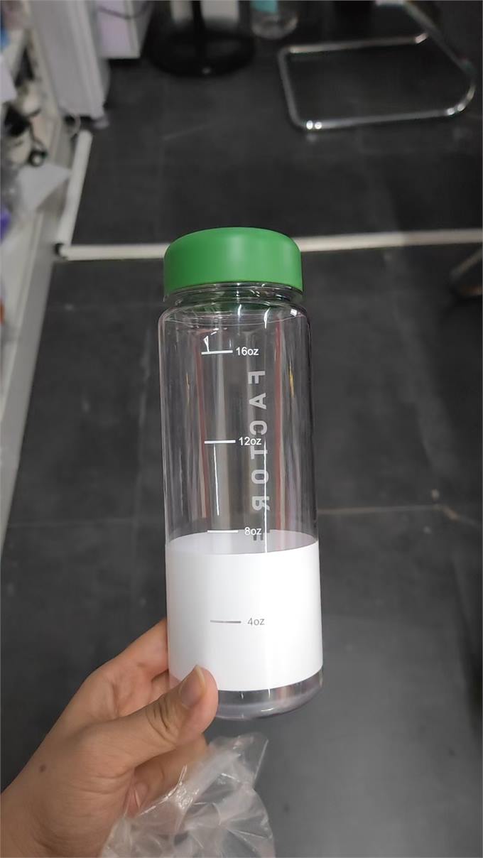 Wide-mouth clear shaker bottle with green lid