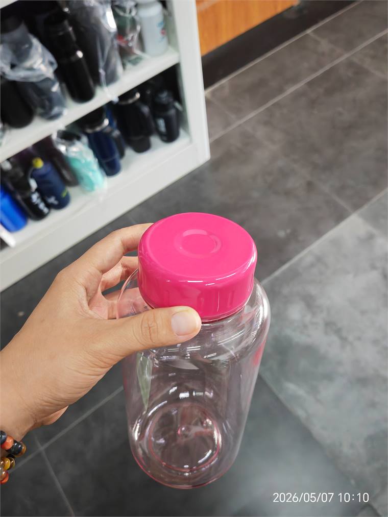 Clear retail bottle with bright pink lid